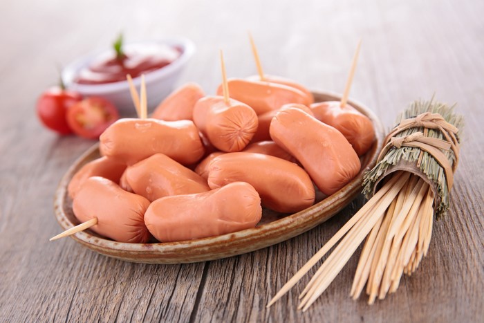 Vienna sausages on a plate with toothpicks