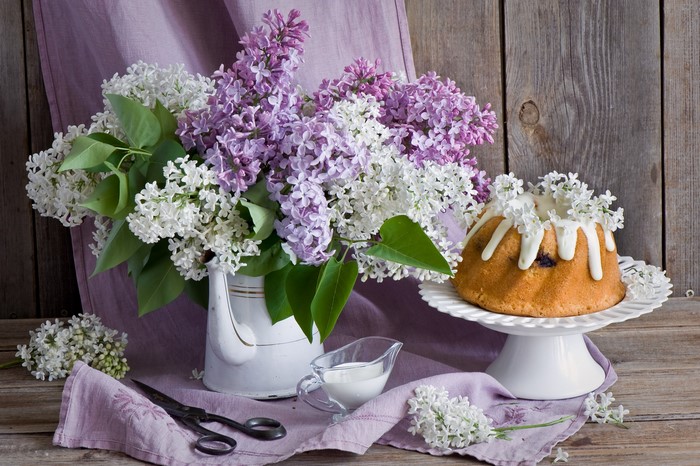 Bundt cake with lilac flowers and scissors