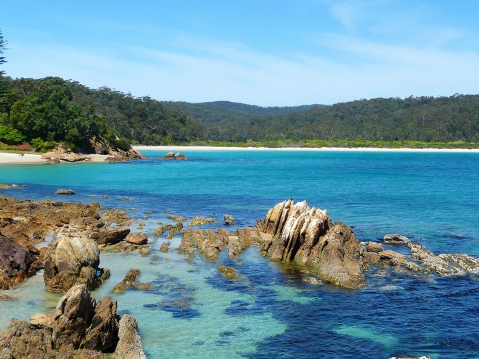 Rocky Coastline with Turquoise Water and Forested Hills
