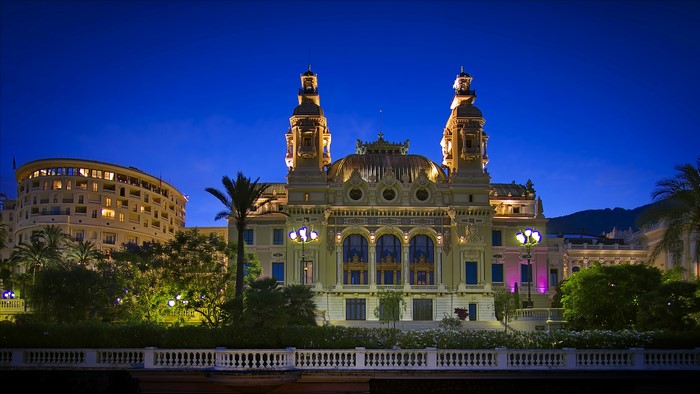 Monte Carlo Casino at night with palm trees