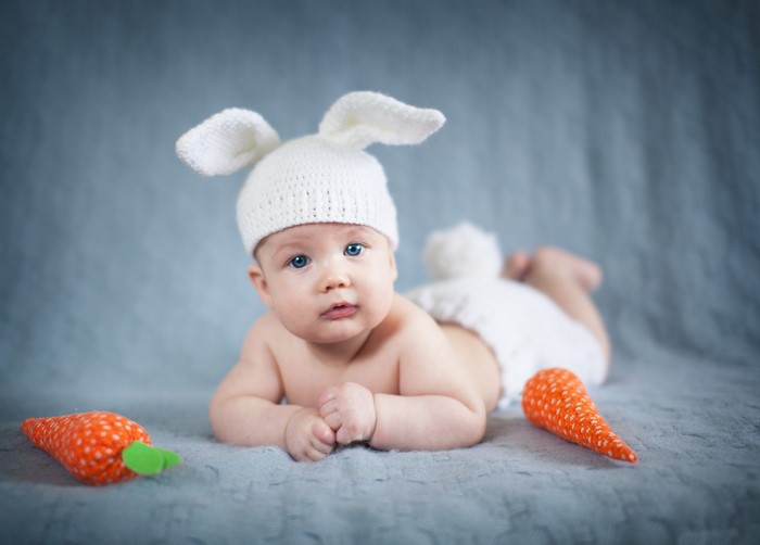 Baby in bunny hat with carrots