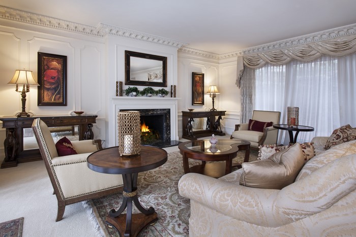 Living room with fireplace, sofa, and tables