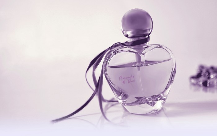 Heart-shaped perfume bottle with ribbon