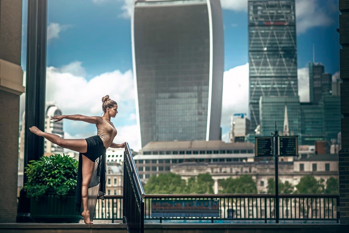 Ballerina performing in front of London skyscrapers