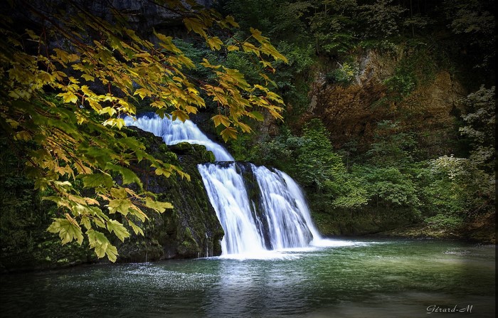 Waterfall in autumn with yellow leaves