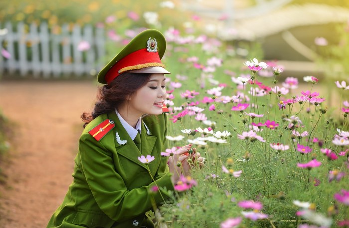 Woman in Vietnamese Police Uniform in Flower Field
