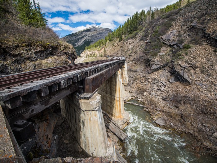 Railroad bridge over a river in a mountainous landscape