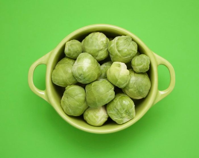 Brussels sprouts in a green bowl