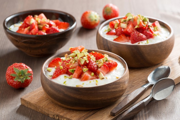 Strawberry Yogurt with Pistachios in Wooden Bowls