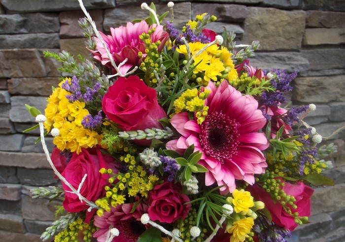 Vibrant floral arrangement with roses and gerbera daisies