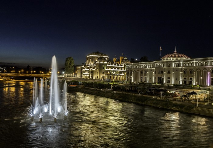 Fountains in front of illuminated buildings at night in Skopje, Macedonia
