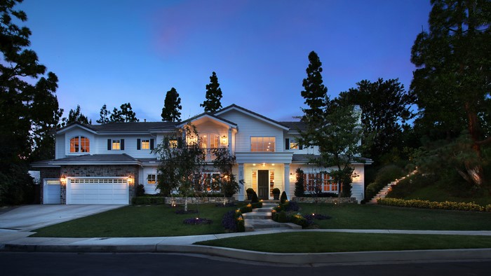 Luxury white house with stone accents at dusk