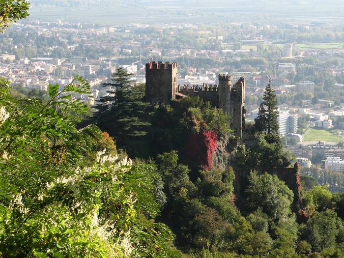 Castle on a hill overlooking a city in Italy
