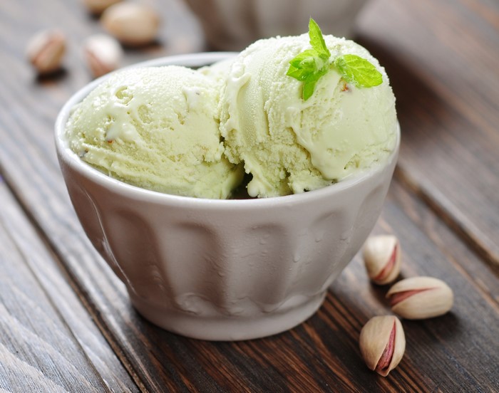Pistachio ice cream in a bowl with pistachios