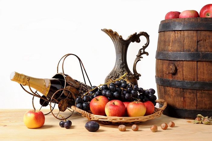 Still-life with wine bottle, apples, grapes, nuts, barrel, and jug