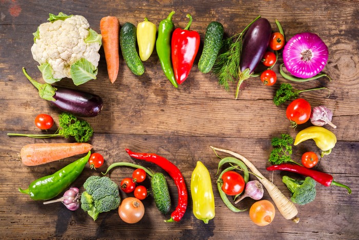 Assortment of fresh vegetables on a wooden table