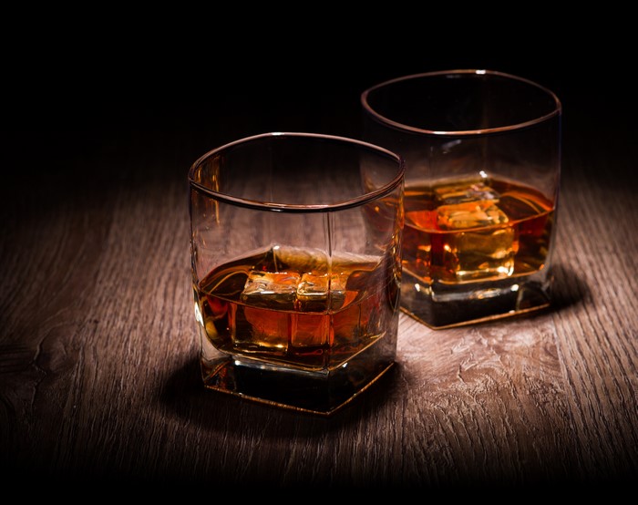 Two glasses of whiskey with ice