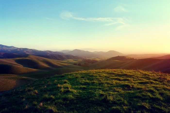 Rolling Hills and Mountains at Sunset