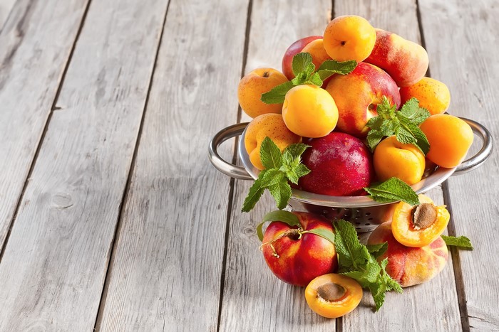 Apricots and peaches in a colander