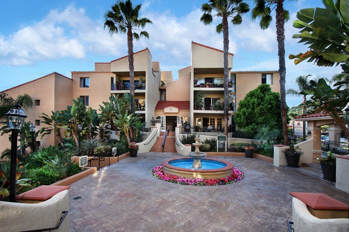 Apartment building with fountain and palm trees