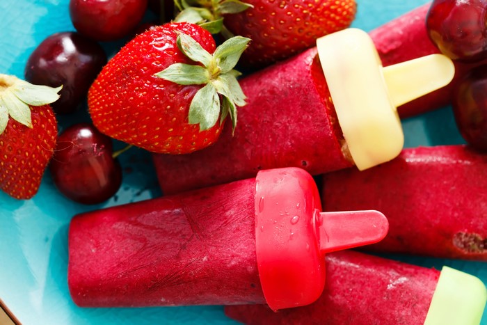 Strawberry and Cherry Popsicles on a Blue Plate
