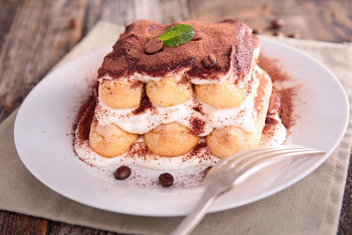 Tiramisu dessert with cocoa powder and mint