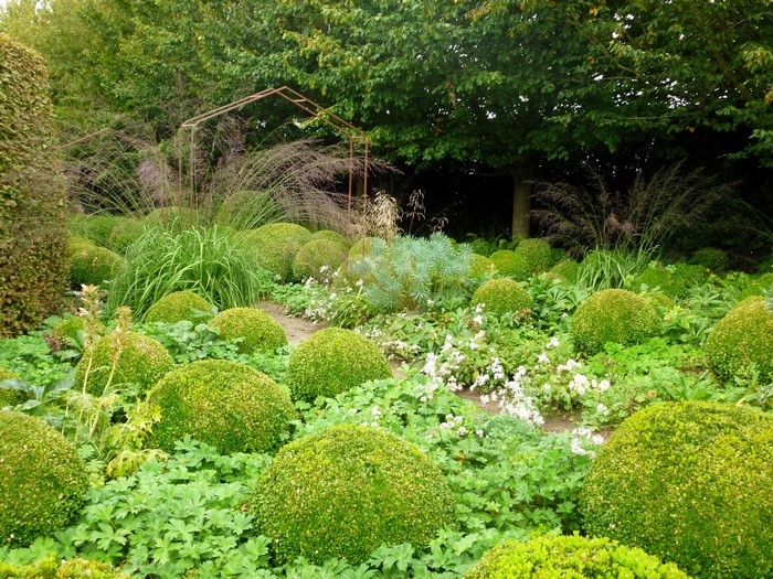 Topiary garden with ornamental grasses and archway