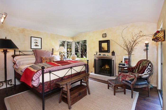 Bedroom with fireplace and armchair