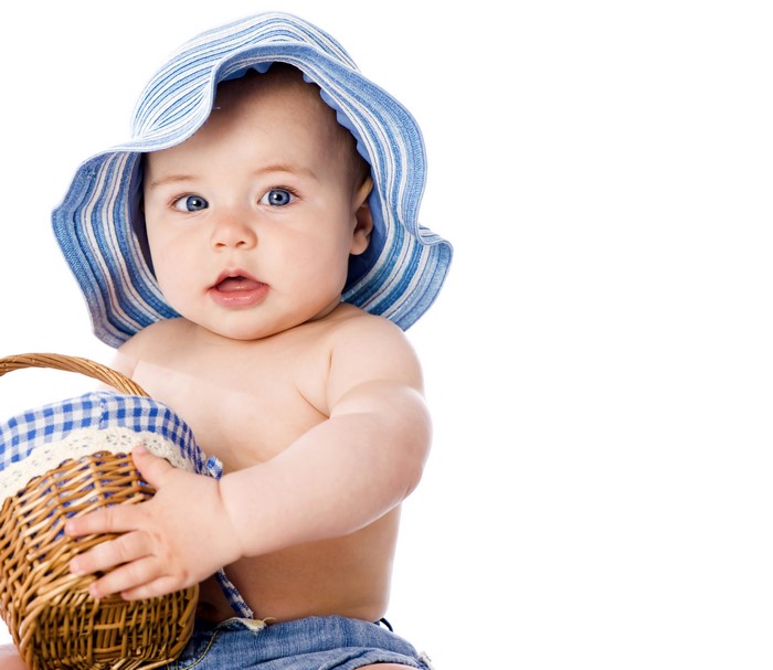 Baby in blue striped hat holding wicker basket