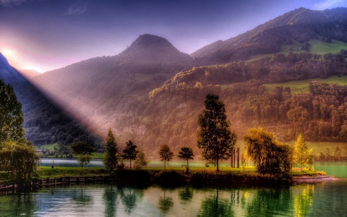 Mountains and lake with sun rays