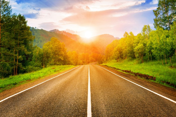 Road through mountains at sunset
