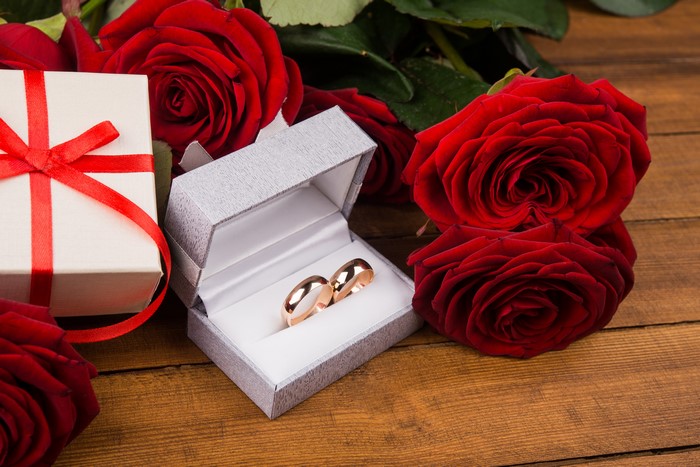 Wedding Rings in a Box with Red Roses and Gift