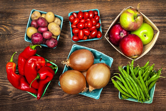 Assortment of fresh vegetables and fruits on a wooden table