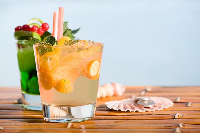 Two refreshing cocktails with fruit and mint