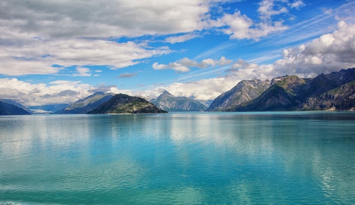 Turquoise water and mountains under a cloudy sky