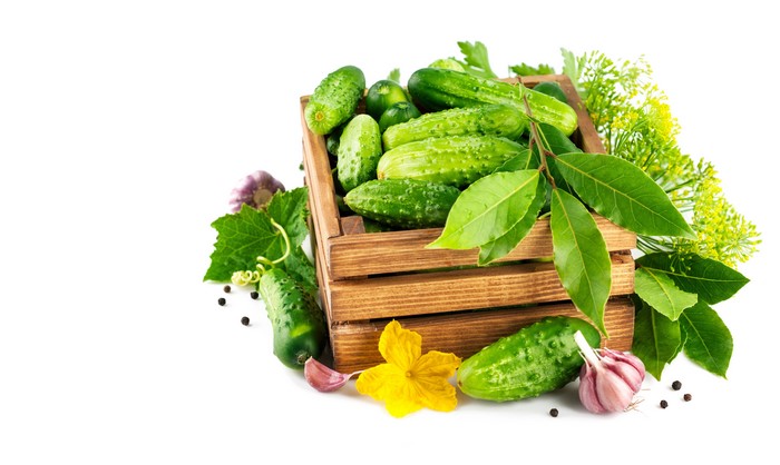 Cucumbers and Garlic in a Wooden Crate