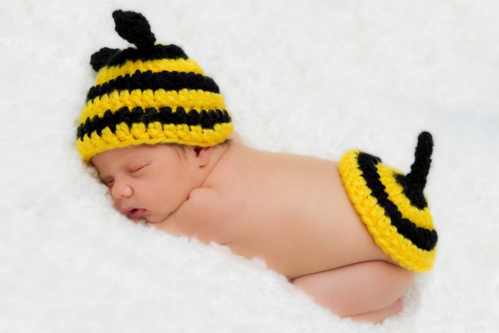 Baby in a bee costume sleeping
