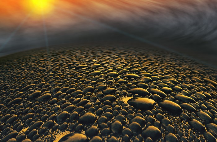 Water droplets on a surface with sun and clouds