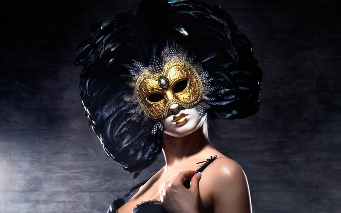 Woman in Venetian masquerade mask with feathers