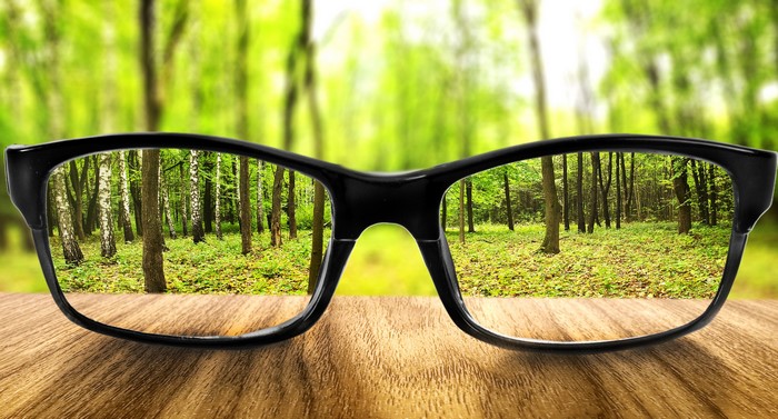 Glasses reflecting a forest scene