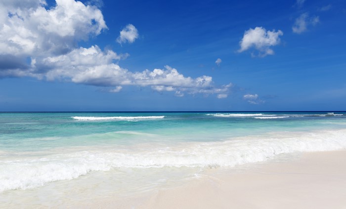 Beach with Turquoise Water and White Clouds