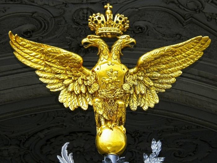 Golden double-headed eagle coat of arms with crown