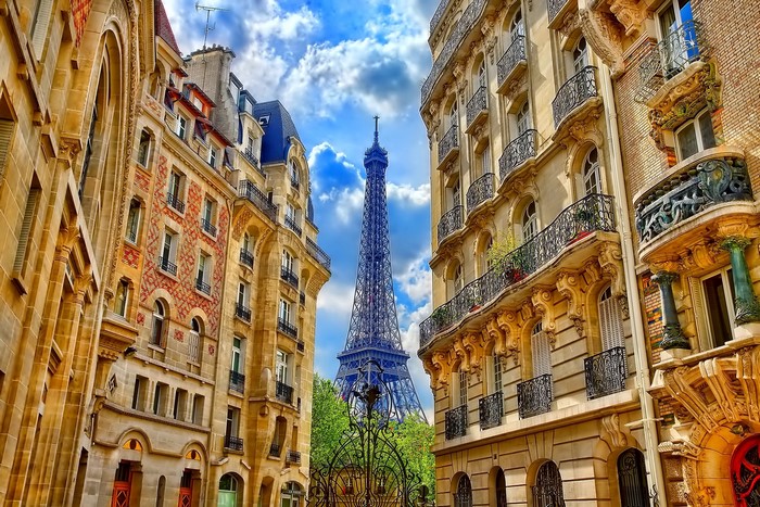 Eiffel Tower viewed between Parisian buildings