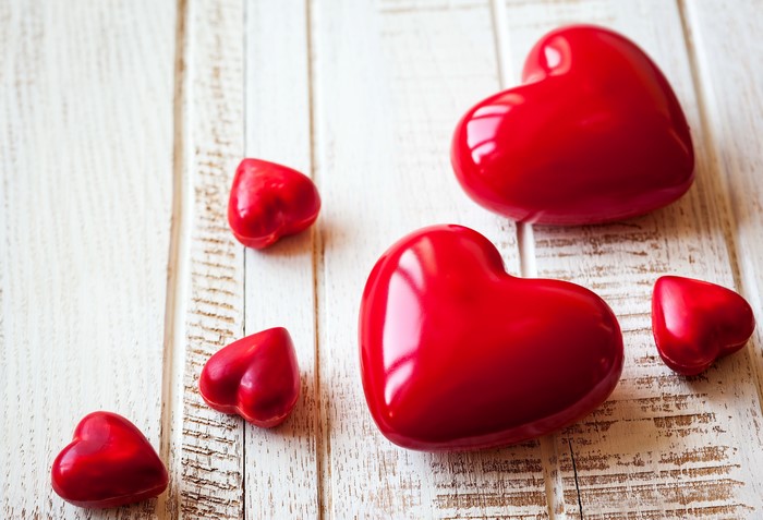 Red hearts on a white wooden background