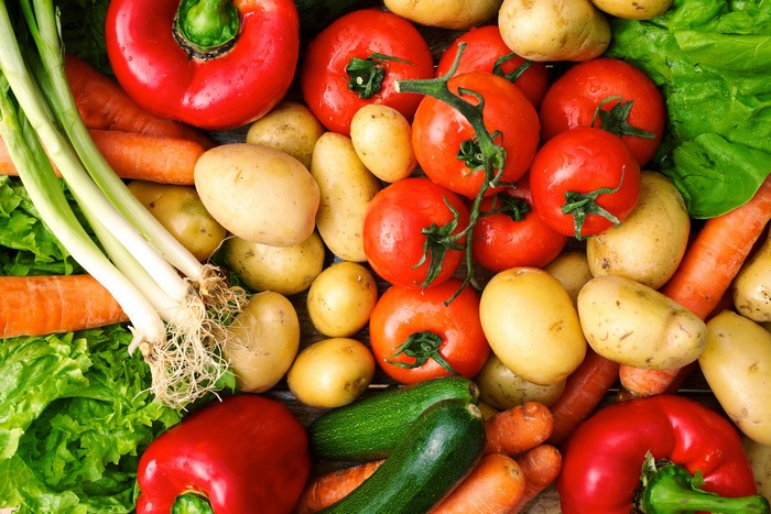 Assortment of fresh vegetables including tomatoes, potatoes, carrots, and peppers