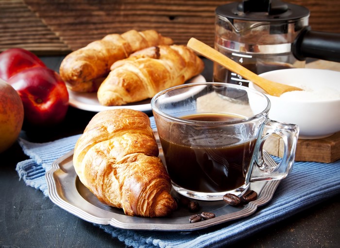 Coffee and croissants with peaches