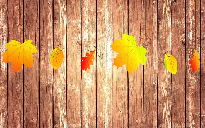 Autumn leaves hanging on wooden planks