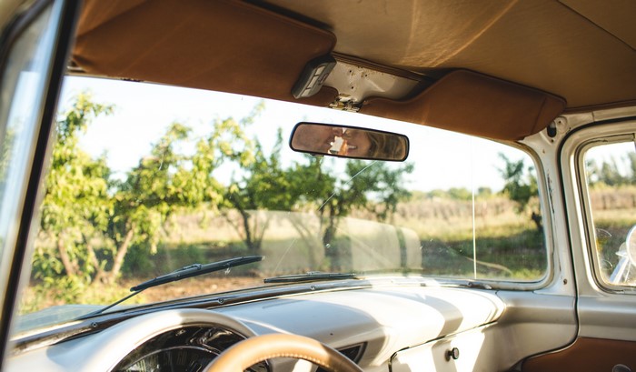Couple kissing in a retro car