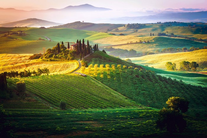 Tuscan landscape with rolling hills and a villa