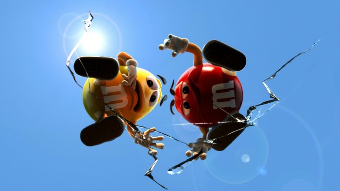 Yellow and Red M&M's characters breaking through glass